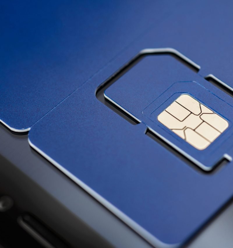 Full-size blue SIM card with pre-cut mini, micro, nano sizes. Macro shot